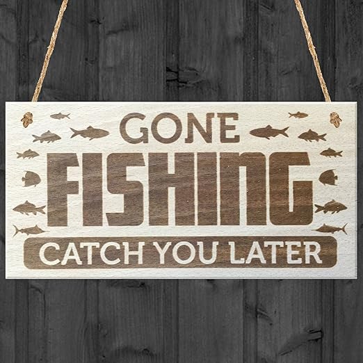 A wooden sign with images of fish reads: Gone Fishing, Catch You Later. Hanging by two ropes against a dark wooden background, it’s one of the coolest fishing gifts and makes a great gift idea for men who love the outdoors. gift idea