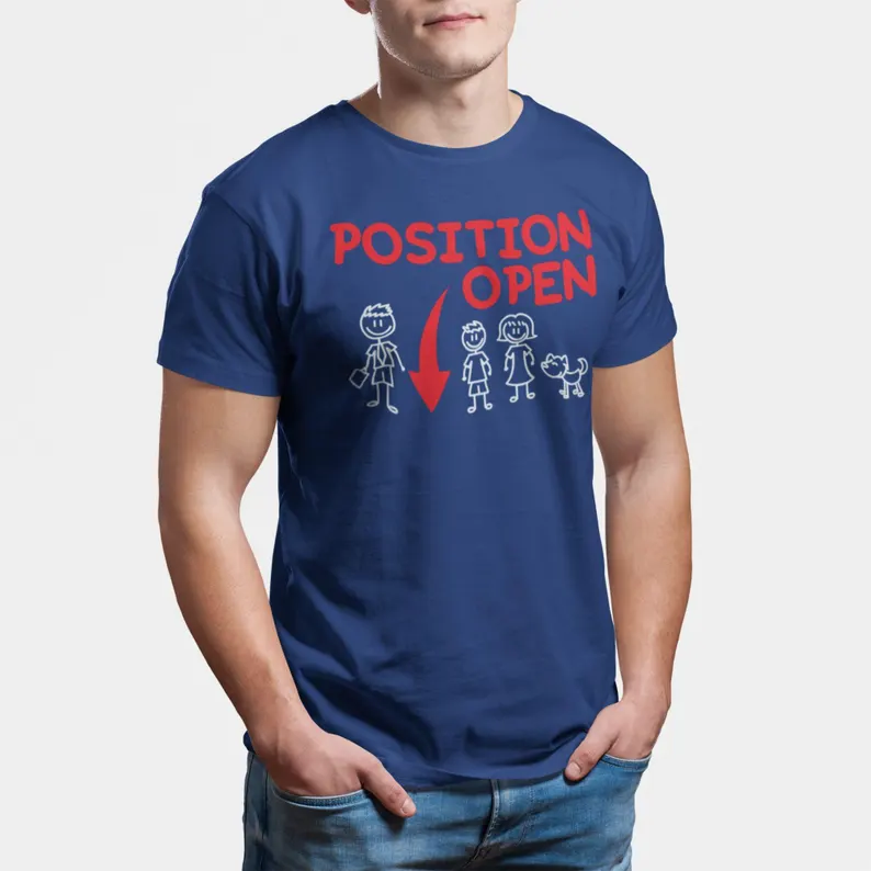 Man wearing a blue t-shirt with stick figure drawings of a man, woman, child, and dog. Above them, red text reads POSITION OPEN with a red arrow pointing to the man—perfect for thoughtful gifts or Father’s Day gifts for single dads. gift idea