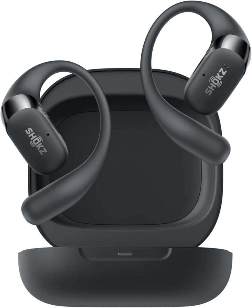 A pair of black Shokz wireless earbuds with ear hooks are positioned above an open charging case, all displayed against a white background—perfect for showcasing your product on Elementor. alwaysagift.co.uk