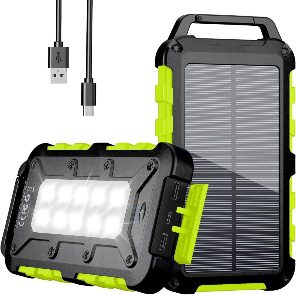 Two rugged black and green portable solar power banks are shown, perfect for Elementor enthusiasts on the go. One displays a solar panel, the other has LED lights illuminated. A short USB charging cable is also included above the devices. alwaysagift.co.uk