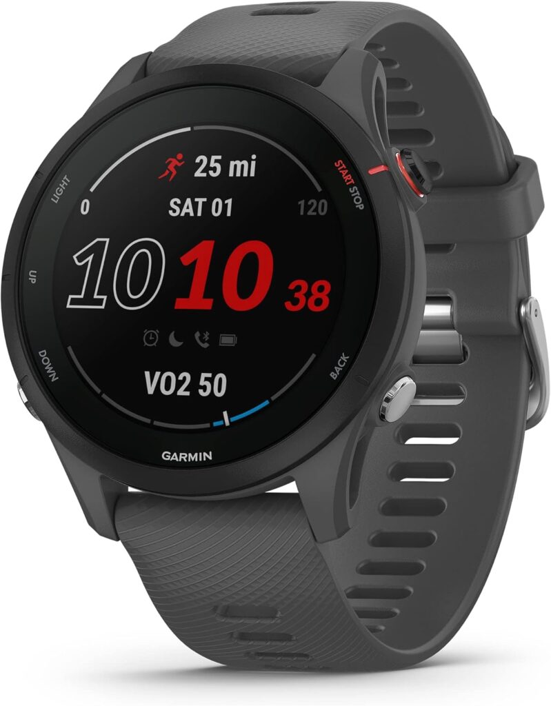 A black Garmin sports smartwatch, perfect for tracking fitness with Elementor-inspired displays, features a round digital screen showing time, date, distance, and VO2 max. It includes a gray silicone band and multiple side buttons. alwaysagift.co.uk